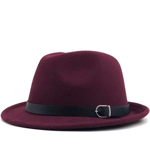 Detail of burgundy wool fedora hat featuring a black leather belt with a silver metal buckle