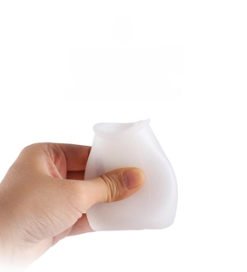 Close-up of flexible silicone oil bottle being squeezed to show high elasticity and soft texture