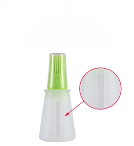 Detail of clear silicone oil bottle with precise ML and OZ measurement scales
