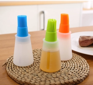 Detailed view of silicone oil brush bottles with scale markings in blue, green and orange