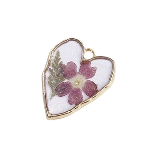Handmade heart-shaped resin earrings with purple dried daisy and gold metal frame
