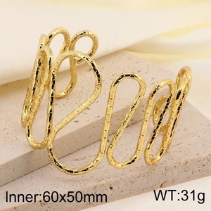 Detail of gold hollow cuff bracelet featuring textured curves and 60x50mm inner diameter