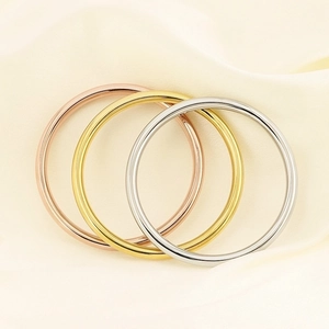6mm hollow titanium steel bangles in gold, rose gold and silver on cream silk