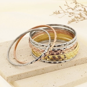 Three-color diamond-cut stackable titanium steel bracelets in gold, silver, and rose gold