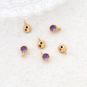 Detailed view of DIY jewelry making accessories with purple zircon in gold plating