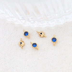 Macro shot of gold-plated connectors with blue zircon gemstones for DIY jewelry