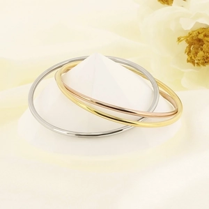 Three-tone minimalist stainless steel bangle set in gold, silver, and rose gold finishes