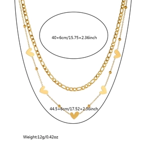 Double layered gold plated stainless steel necklace with heart charm and Figaro chain details