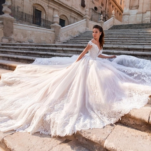 Elegant off-the-shoulder lace bridal gown with a long train and floral embroidery