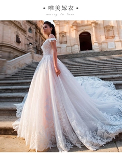 Close-up of elaborate floral lace embroidery on high-density wedding dress fabric