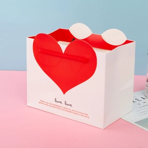 White festive paper gift bag with red heart design and love love quote for Mother's Day