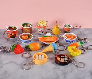 Detailed view of assorted PVC food miniature keychains including noodles and popcorn