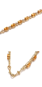 Detail of 18k gold plated bracelet featuring yellow gemstones and floral accents