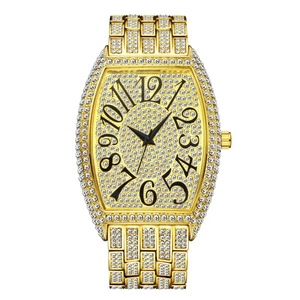 Detail of tonneau-shaped gold watch case and band fully paved with clear diamonds