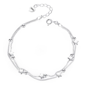 Double-layered 925 sterling silver star and bead bracelet with heart charm on white background