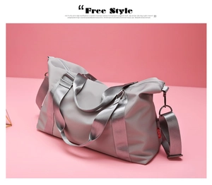 Close-up of grey waterproof fitness bag with durable handles and adjustable shoulder strap
