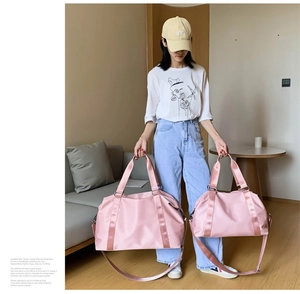 Pink waterproof nylon gym bags in two sizes with reinforced handles and shoulder straps