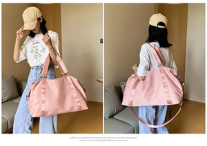 Pink waterproof yoga bag showing dual handle and adjustable shoulder strap detail