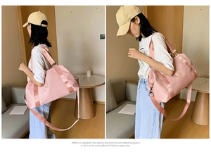 Pale pink fitness bag with wet dry separation and shoulder straps for travel