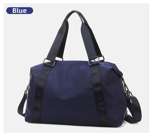 Detail of blue waterproof fitness bag with adjustable shoulder strap and durable handles