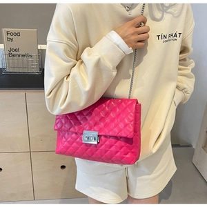 Detail of rose pink quilted chain bag with silver twist lock and luxury embroidery