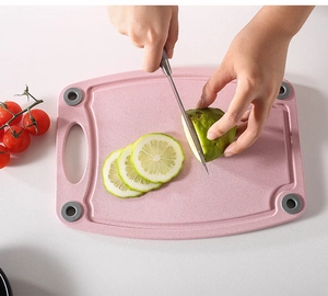Tagliere rosa in paglia di grano con piedini antiscivolo mentre si affetta la frutta