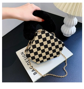 Detail of hexagonal checkerboard bag with plush faux fur handle and gold chain strap
