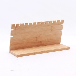Detail of natural bamboo necklace display stand with multiple serrated groove hooks