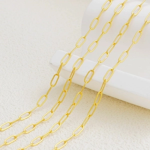 Macro detail of 18K gold plated oval link paperclip chain for DIY jewelry making