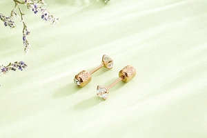 Macro shot of rose gold stud earring featuring a four-claw set cubic zirconia detail