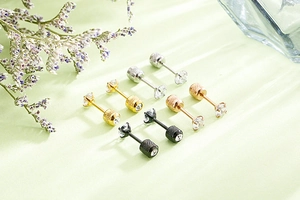 Detail of four-pair surgical steel screw back studs with zircon in four metallic colors