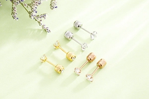 Three pairs of screw-back zircon studs in silver, gold, and rose gold plating