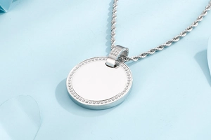 Detailed view of silver titanium steel circular pendant with sparkling CNC set crystals