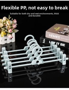 Macro view of blue plastic adjustable pants hanger with durable swivel clips for skirts