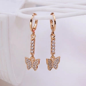 Elegant gold butterfly dangle earrings with clear zircon crystals on white grid stand