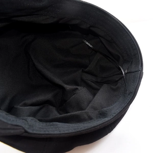 Internal view of black newsboy cap featuring adjustable drawstring and textile lining