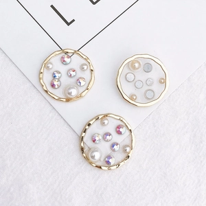 Three elegant gold-edged round charms with white faux pearls and iridescent rhinestones