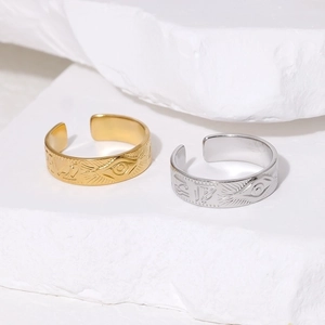 Retro Eye of Horus open rings in gold and silver finish on white stone texture