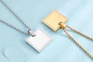Detail of square zircon necklaces in silver and gold finishes with twisted chains
