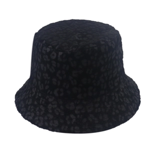 Detail view of the black leopard print texture on a warm reversible bucket hat