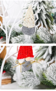 Detail of Christmas gnomes with sequined hats hanging on white branches for decoration