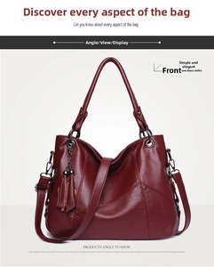 Front view of a burgundy leather handbag with tassel charm and polished litchi texture