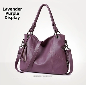 Detail of taro purple leather tote bag showing soft texture and side tassel pendant