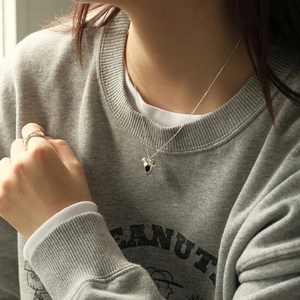 S925 Sterling silver heart necklace with black enamel pendant worn by a model