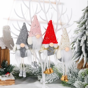 Set of four hanging sequin Christmas gnomes with long legs on a white branch