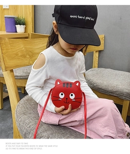 Toddler girl red cartoon cat purse worn by child model with white top and black cap