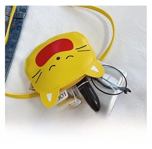 Detail of yellow mini crossbody bag interior showing space for perfume and lipstick