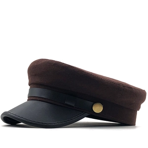 Detail of vintage navy cap with brown wool blend crown and black leather visor