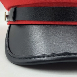 Classic red and black newsboy hat with PU leather brim and golden metal button detail