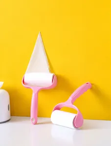 Detail view of pink lint roller with peel-off adhesive paper for household clothes cleaning